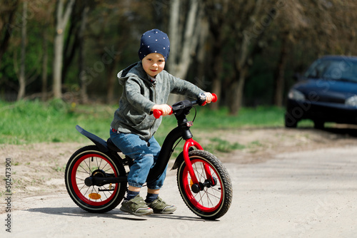 boy riding a bike on the street. Learning to ride a bike concept © Ruslan Ivantsov