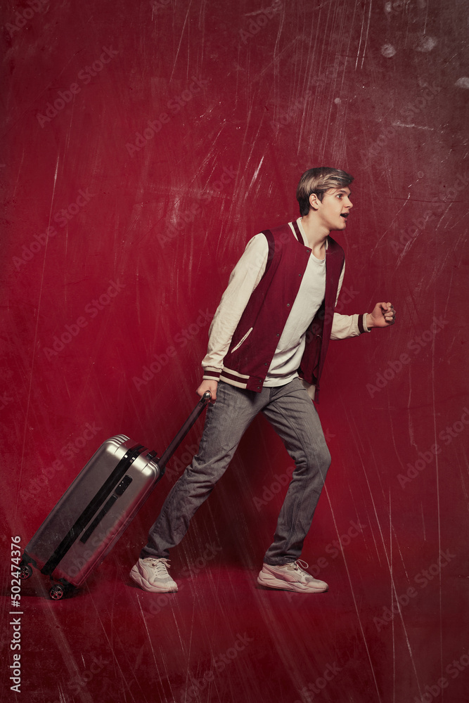 Young excited caucasian man tourist with suitcase Young excited caucasian man tourist with suitcase