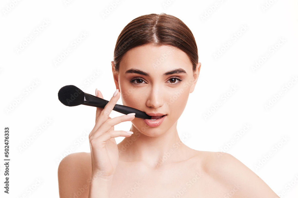 young beautiful woman with make-up brush for powder young beautiful woman with make-up brush for powder