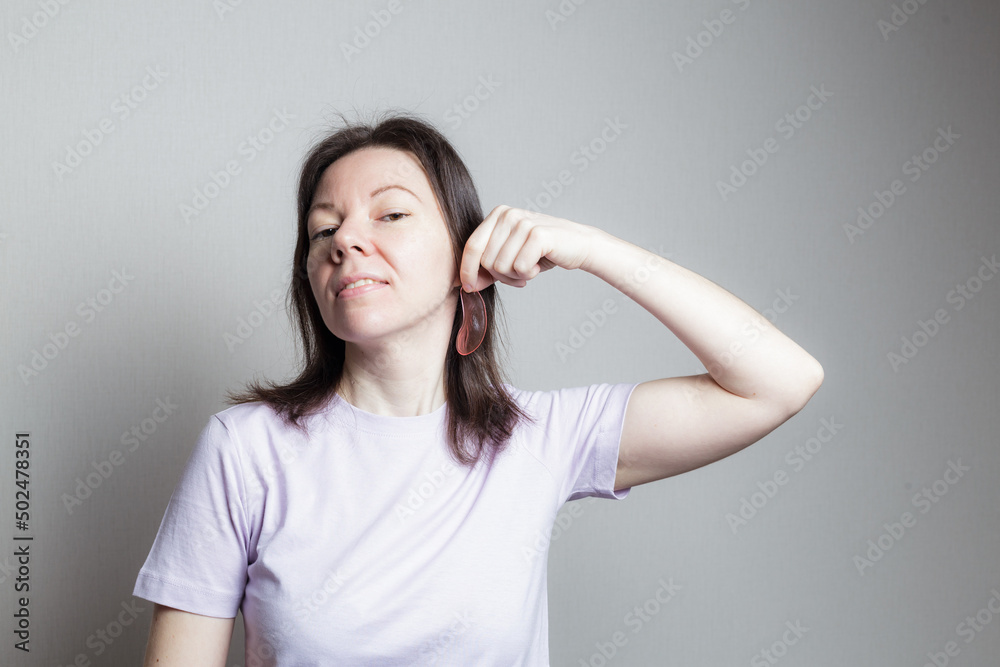 woman woman smiling and joking trying on an eye patch instead of earrings woman woman smiling and joking trying on an eye patch instead of earrings