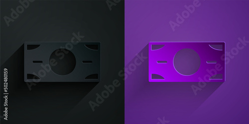 Paper cut Stacks paper money cash icon isolated on black on purple background. Money banknotes stacks. Bill currency. Paper art style. Vector