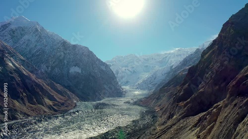 Aerial Panning A Wide Glacier Surrounded By Steep Snowcapped Mountains - Hunza Valley, Pakistan photo