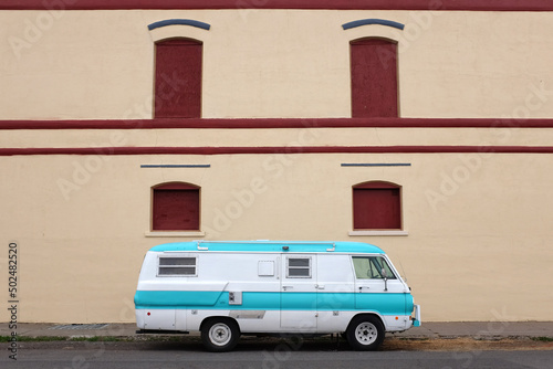 Vintage camper in front tan wall.