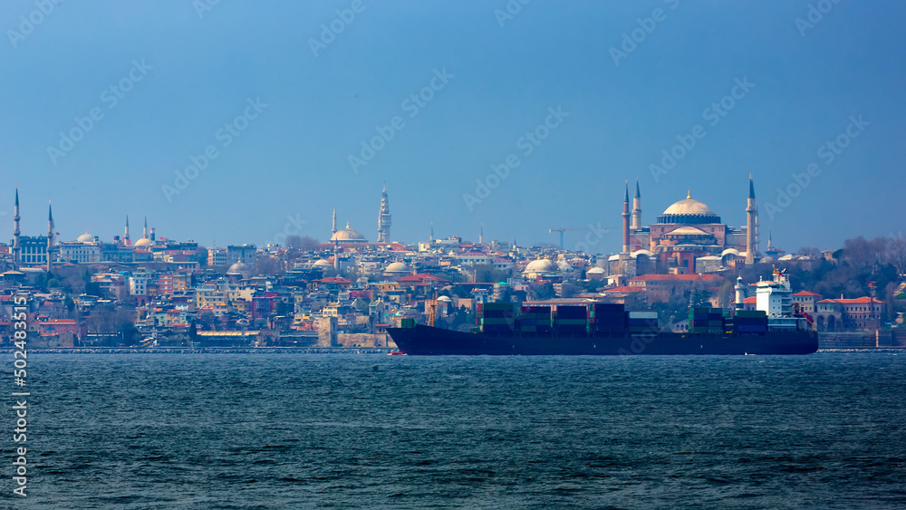 Container ship in Bosphorus with in Background Hagia Sophia. Istanbul, Turkey.