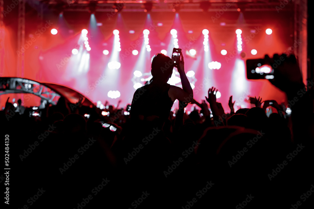 Girl on shoulders in the crowd at a music festival