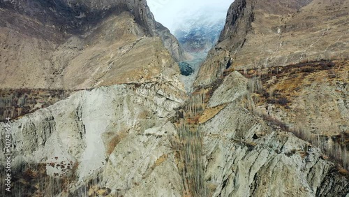 Aerial Panning A Remote Ravine Between Two Soaring Mountainsides - Hunza Valley, Pakistan photo