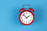 Retro red clock on a blue background