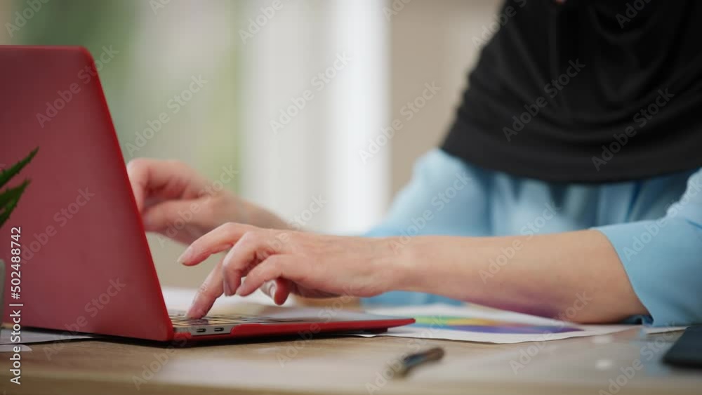 Hands of unrecognizable woman in hijab typing on laptop keyboard indoors. Intelligent confident female freelancer working online surfing Internet. Remote work and lifestyle Hands of unrecognizable woman in hijab typing on laptop keyboard indoors. Intelligent confident female freelancer working online surfing Internet. Remote work and lifestyle