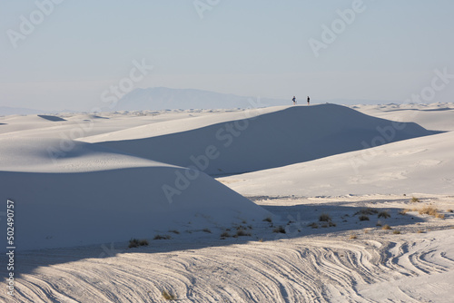A couple on top of sand dunes in White Sands National Park © James