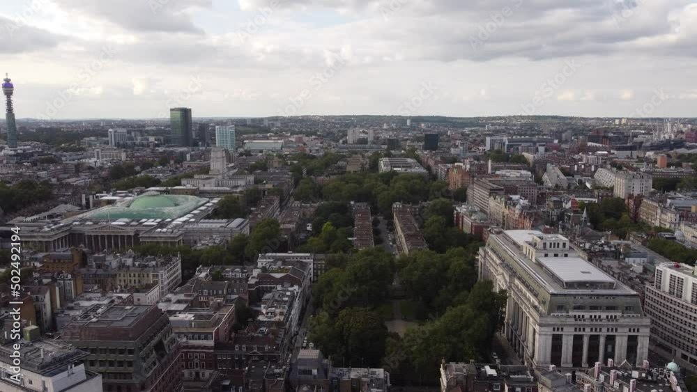 Drone view of a green island of trees in the middle of the metropolis. Drone view of a green island of trees in the middle of the metropolis.