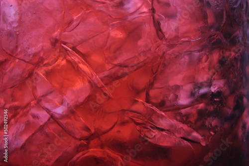 roselle juice in a glass, placed on a white table.
