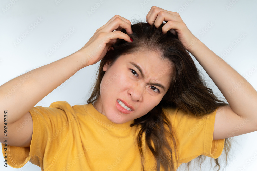 Asian woman scratching her scalp caused of itchy scalp. Asian woman scratching her scalp caused of itchy scalp.