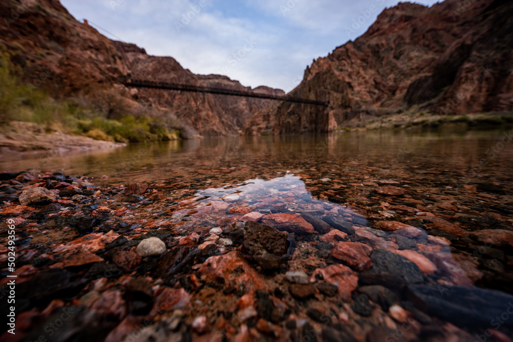 Submerged Rocks in the Colorado River with the Black Bridge