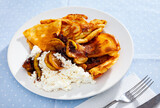 Appetizing sweet crepes with cottage cheese and baked sliced apples with cinnamon