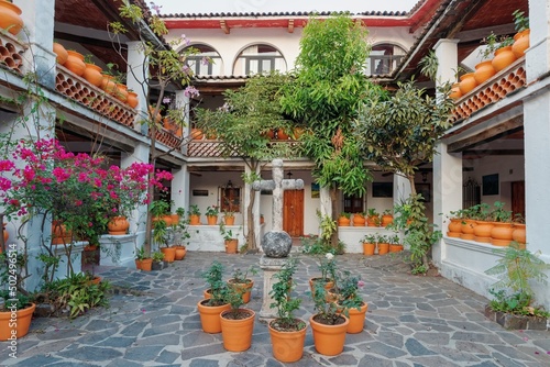 Colonial style patio. Large flower pots, cross, columns. Taxco city in Mexico