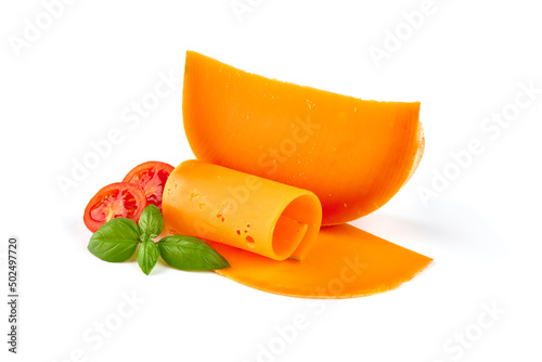 Wedge of orange French Mimolette cheese isolated on white background.