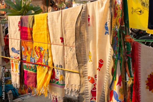 Colorful saris, traditional Indian women wear, are hanging for sale. Handicrafts fair. Handicrafts are popular rural Industry in West Bengal.