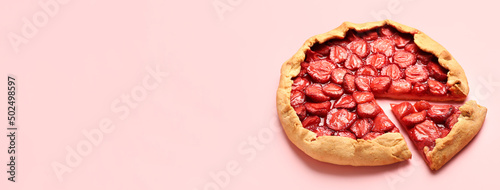 Tasty strawberry pie on pink background with space for text