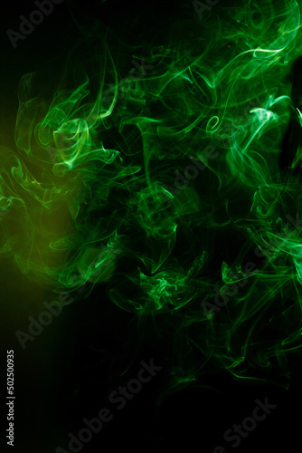 Green smoke motion on black background.