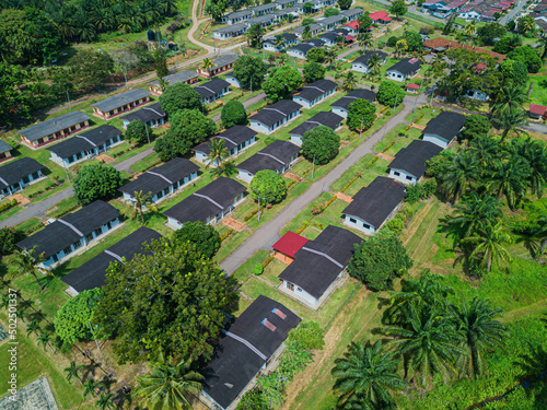 Aerial drone view of workers settlements near oil palm plantations area in Asahan, Melaka, Malaysia.