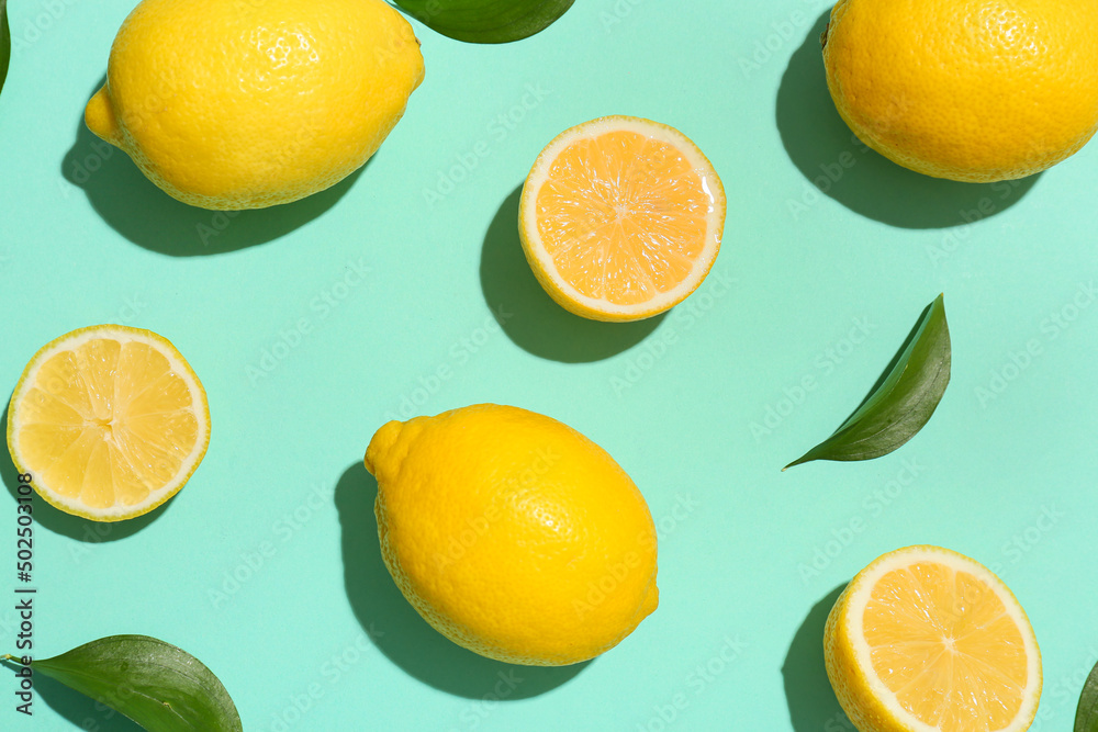 Ripe lemons and slices on turquoise background, top view Ripe lemons and slices on turquoise background, top view