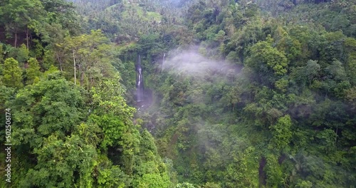 Sekumpul waterfalls, Bali, Indonesia. Aerial drone view, slowly enetring a valley through the mist. photo