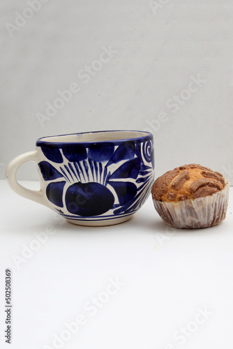 Fresh, delicious and fluffy Mexican bread Manteconchas cupake type vanilla and chocolate flavor accompanied by coffee on a white background traditional of the culture of Mexico
 photo