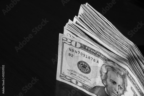 stack of twenty american dollars banknotes on table, close up