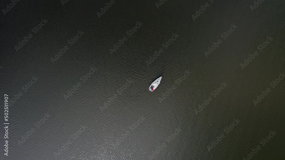 Top down view of small sailing boat making a course change in calm conditions, Netherlands Top down view of small sailing boat making a course change in calm conditions, Netherlands