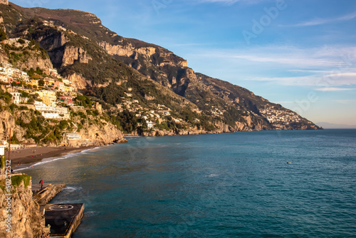 Panoramic view from Fornillo Beach on the coastal towns Positano and Praiano at the Amalfi Coast, Italy, Campania, Europe. Vacation at the mountainous and hilly coastline of the Mediterranean Sea