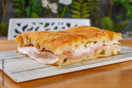Focaccia romana ripiena di mortadella e stracciata di bufala servita in una rosticceria photo