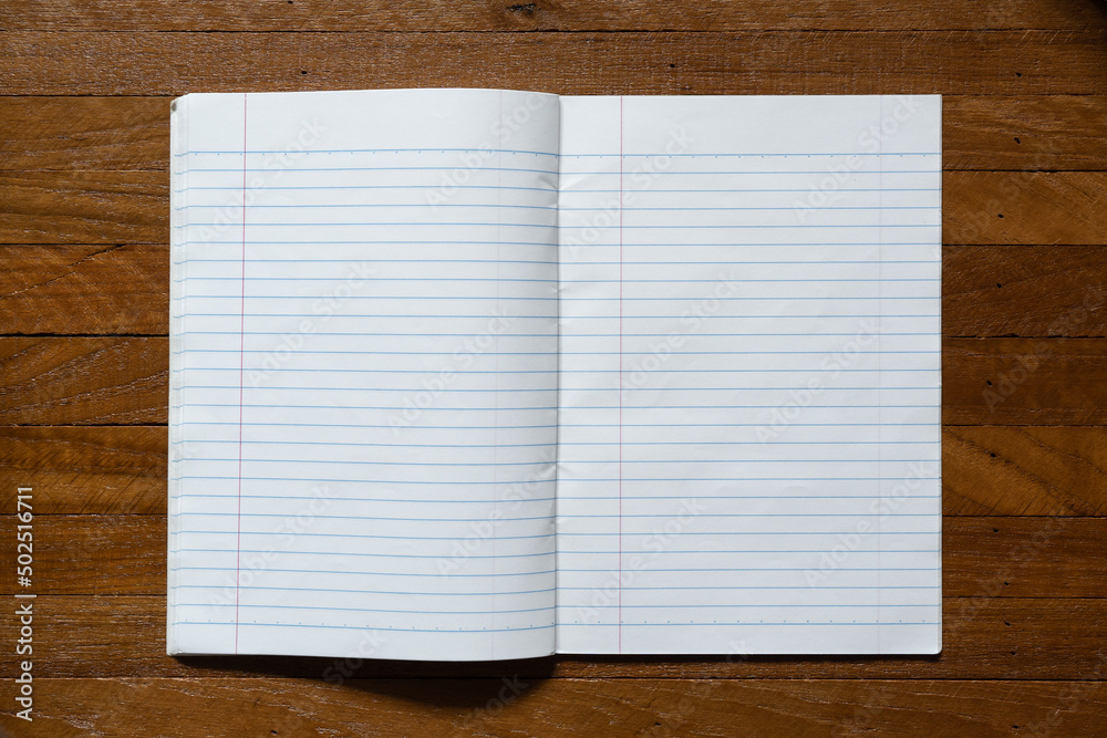 Ruled paper notebook on wooden table Ruled paper notebook on wooden table