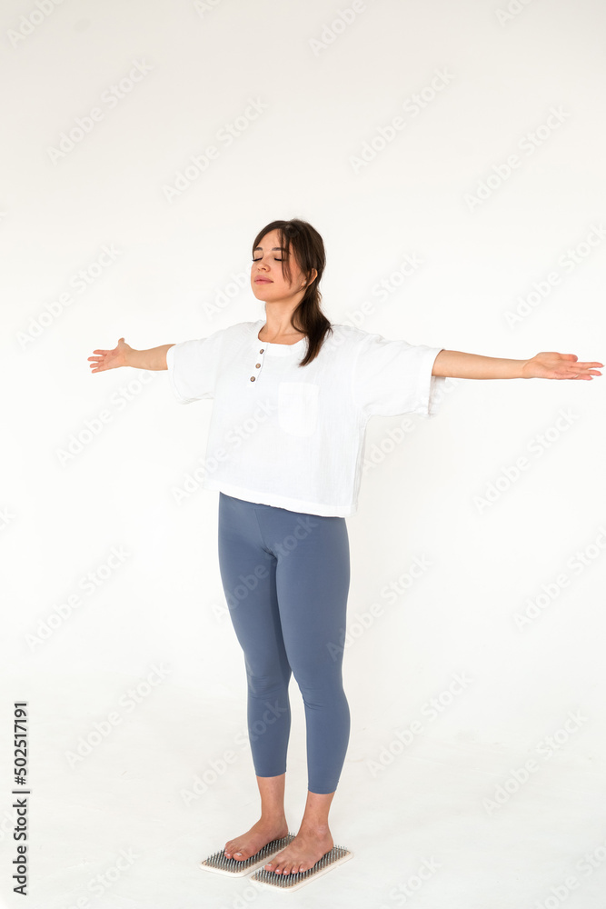 Alternative medicine and mindfulness practice - standing on sadhu board nails barefoot Alternative medicine and mindfulness practice - standing on sadhu board nails barefoot