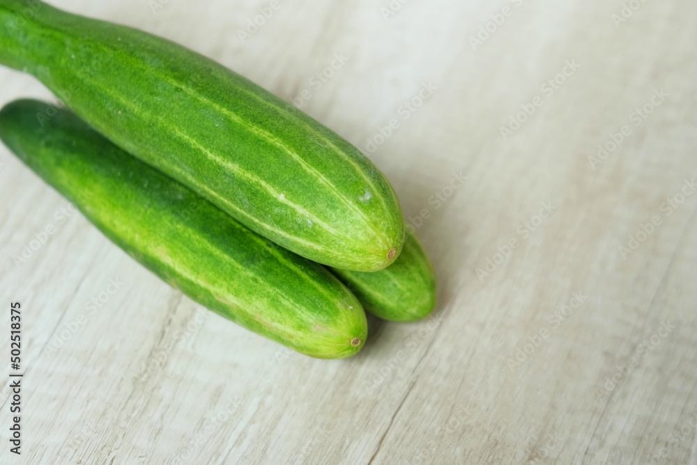 cucumbers on a wooden background cucumbers on a wooden background