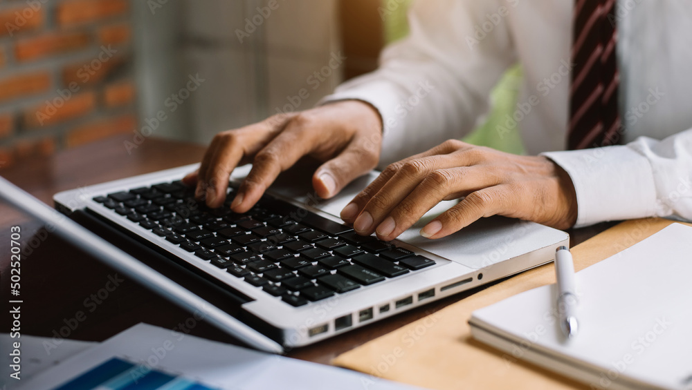 Businessman or student using laptop at home, Man hands typing on computer keyboard closeup, online learning, internet marketing, working from home. Businessman or student using laptop at home, Man hands typing on computer keyboard closeup, online learning, internet marketing, working from home.