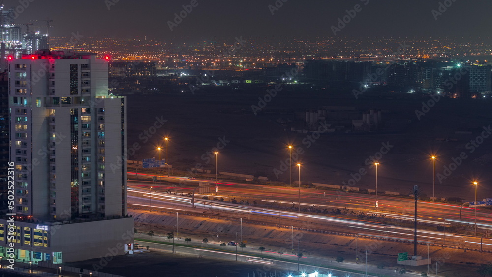 Towers and road at the Business Bay aerial night timelapse in Dubai, United Arab Emirates