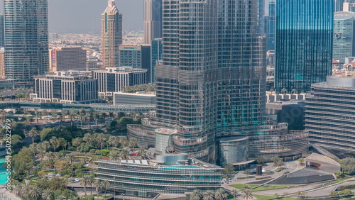 Skyscrapers in downtown with metro link overpass and traffic on the road timelapse. Dubai, United Arab Emirates