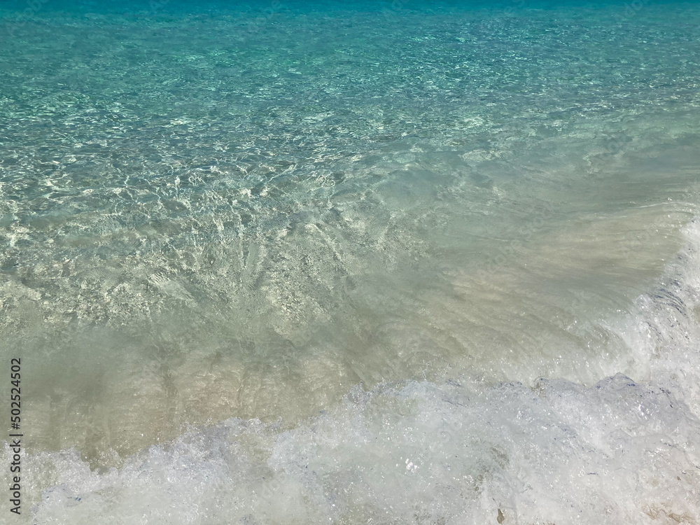 big splash sea waving on white sand beach with crystal clear Andaman blue sea in daylight