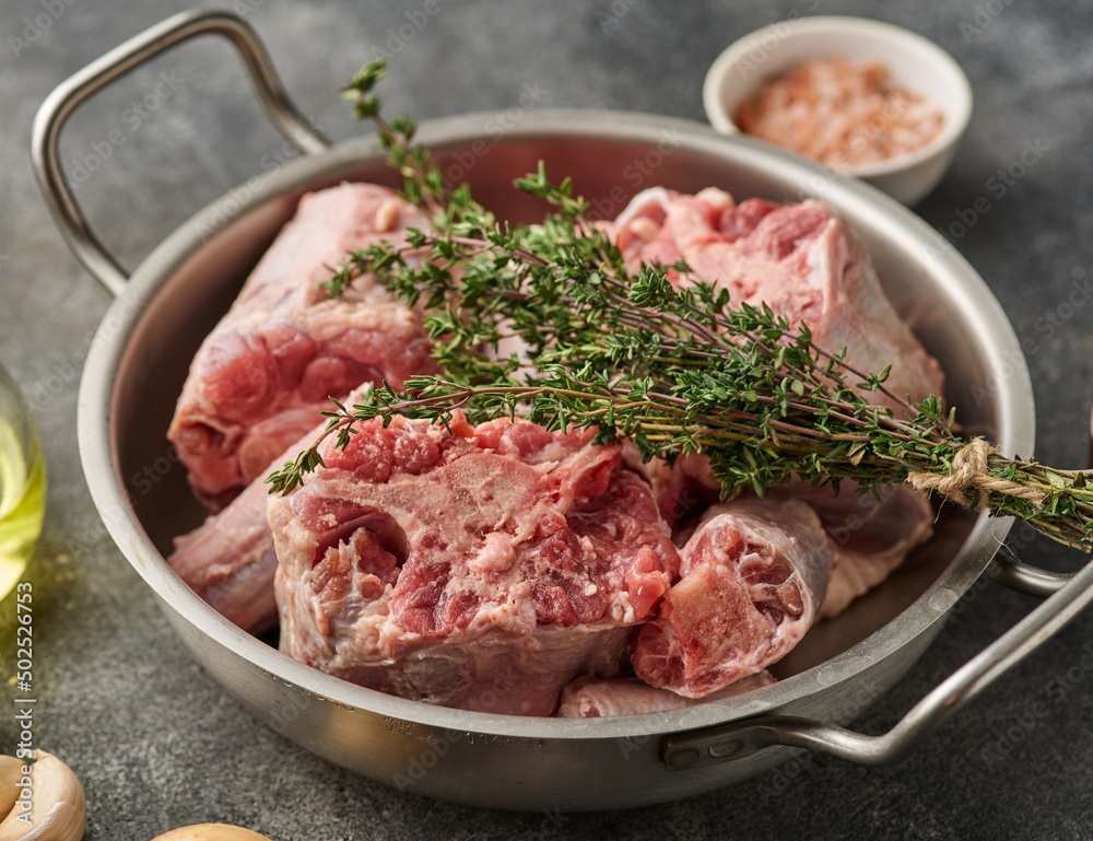 Oxtail Bones Being in Stainless Steel Skillet.