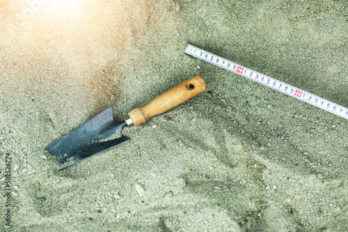 Shovel in the sand.Skeleton and archaeological tools.Digging for fossils. photo