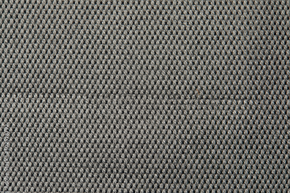 Knitted texture. Texture of jacquard fabric with gray geometric pattern. Crochet mosaic pattern. Knitted texture. Texture of jacquard fabric with gray geometric pattern. Crochet mosaic pattern.