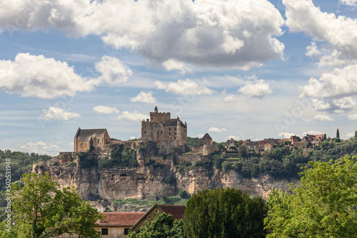 Chateau de Beynac, with its austere appearance, is perched on top of limestone cliff, dominating Vezak commune beneath and north bank of Dordogne river, France