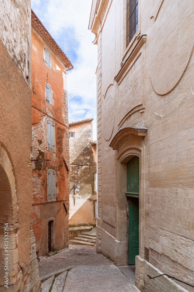 Dense ancient buildings and architecture of tiny French town Gordes on cliff, Vaucluse, Provence, Alpes, Cote d'Azur, France (vertical photo)