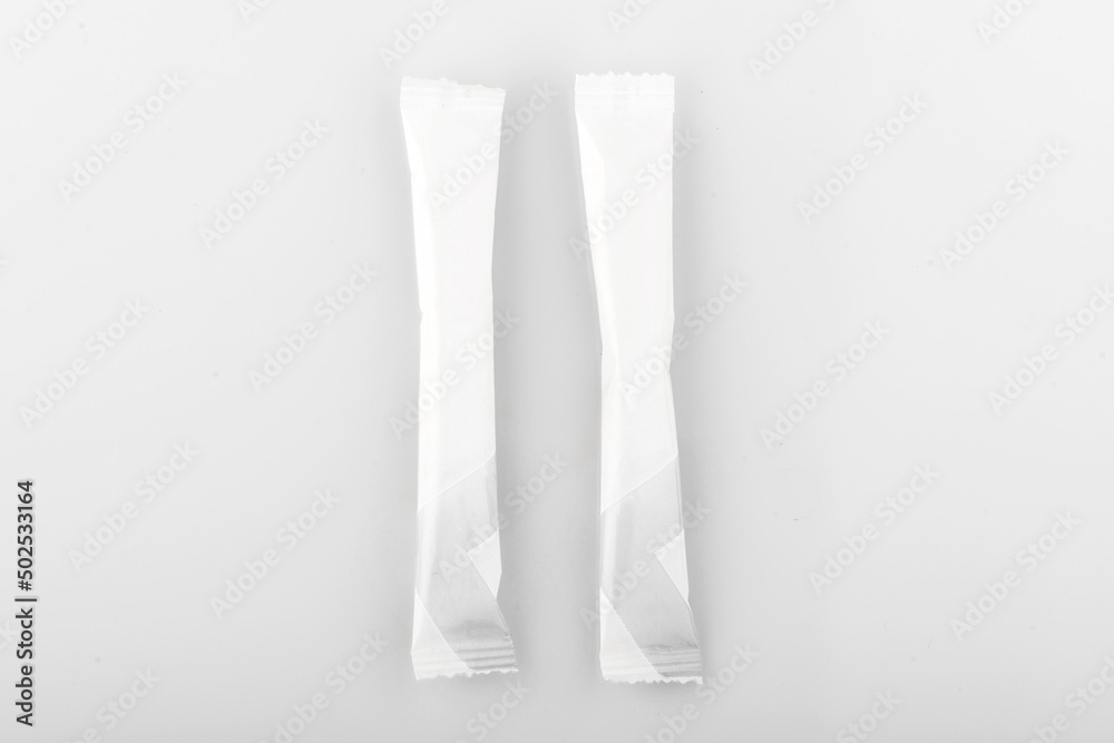 Sugar stick. Sugar in paper kraft packaging. Mock up for design isolated on white background Sugar stick. Sugar in paper kraft packaging. Mock up for design isolated on white background