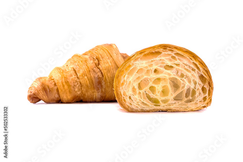 Plain Croissants and cut in half, showing the cross section, a classic crescent-shaped croissant. isolated on a white background.
