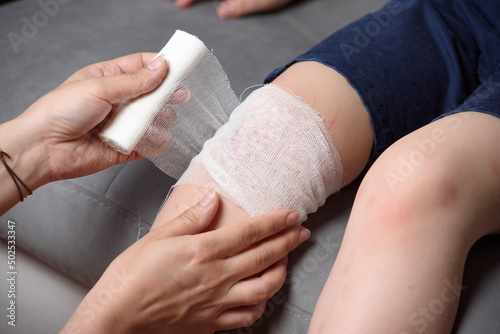 Treatment of wounded children's knees. Bandaging. Step by step.