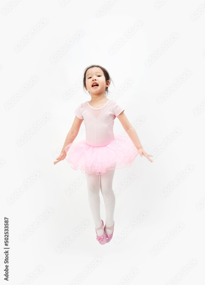 The beautiful little girl is doing gymnastics on a white background The beautiful little girl is doing gymnastics on a white background