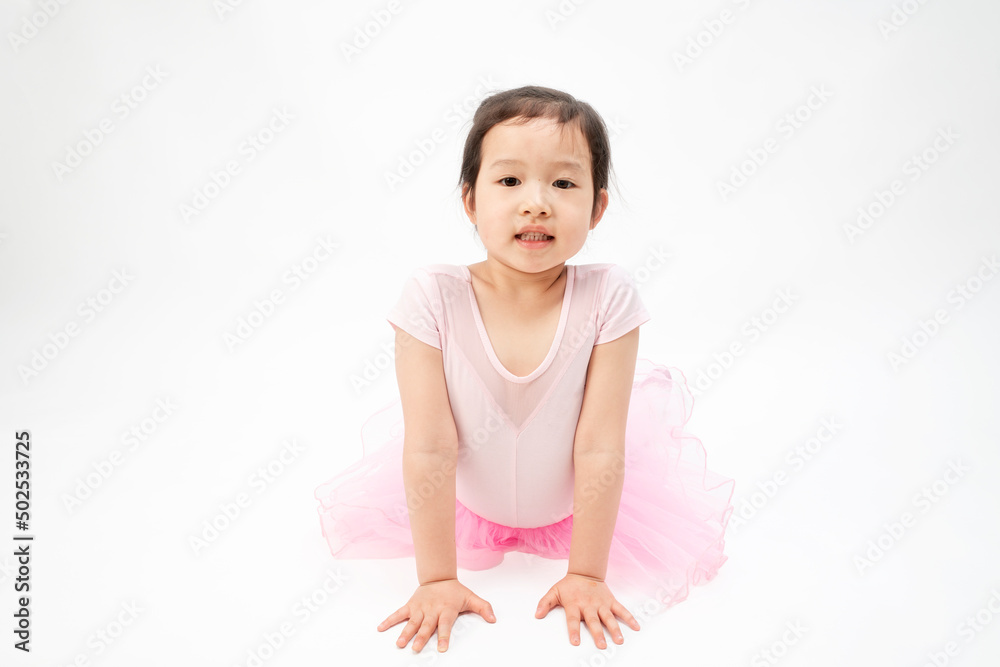 The beautiful little girl is doing gymnastics on a white background The beautiful little girl is doing gymnastics on a white background