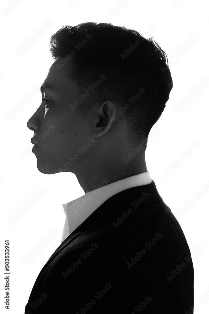 Black and White portrait of handsome Asian male model with beautiful eyes wearing suit in the light white background. Black and White portrait of handsome Asian male model with beautiful eyes wearing suit in the light white background.