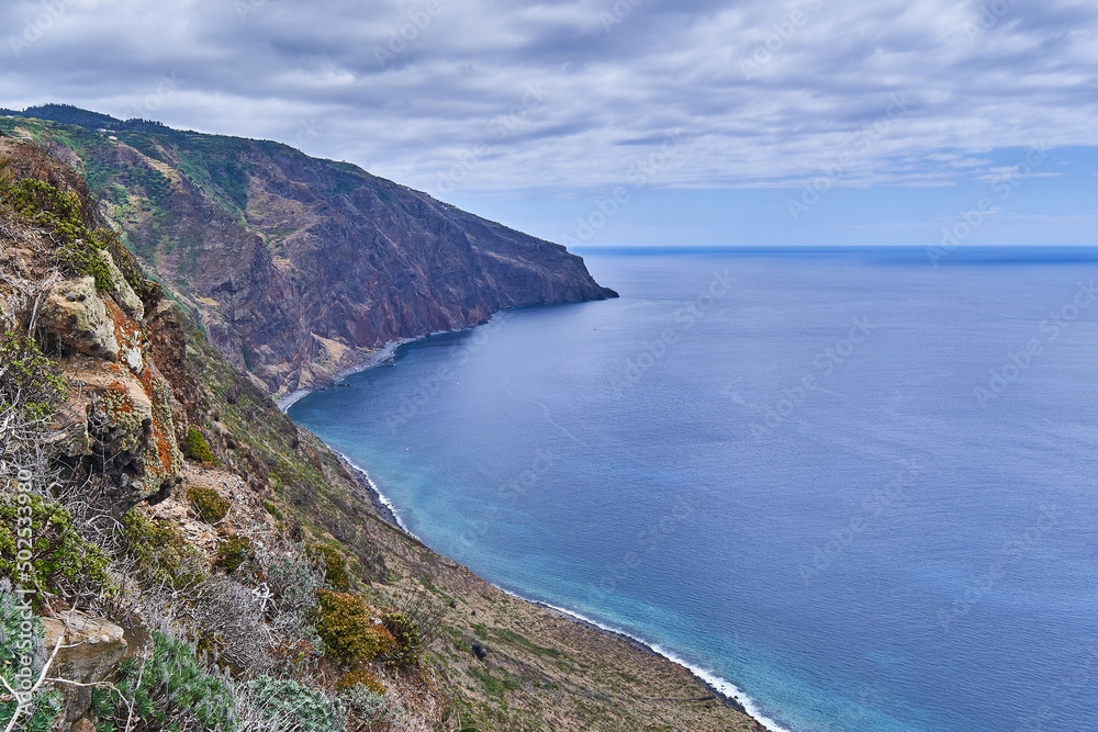 Rocky coast of Madeira with cliffs, coast of the island